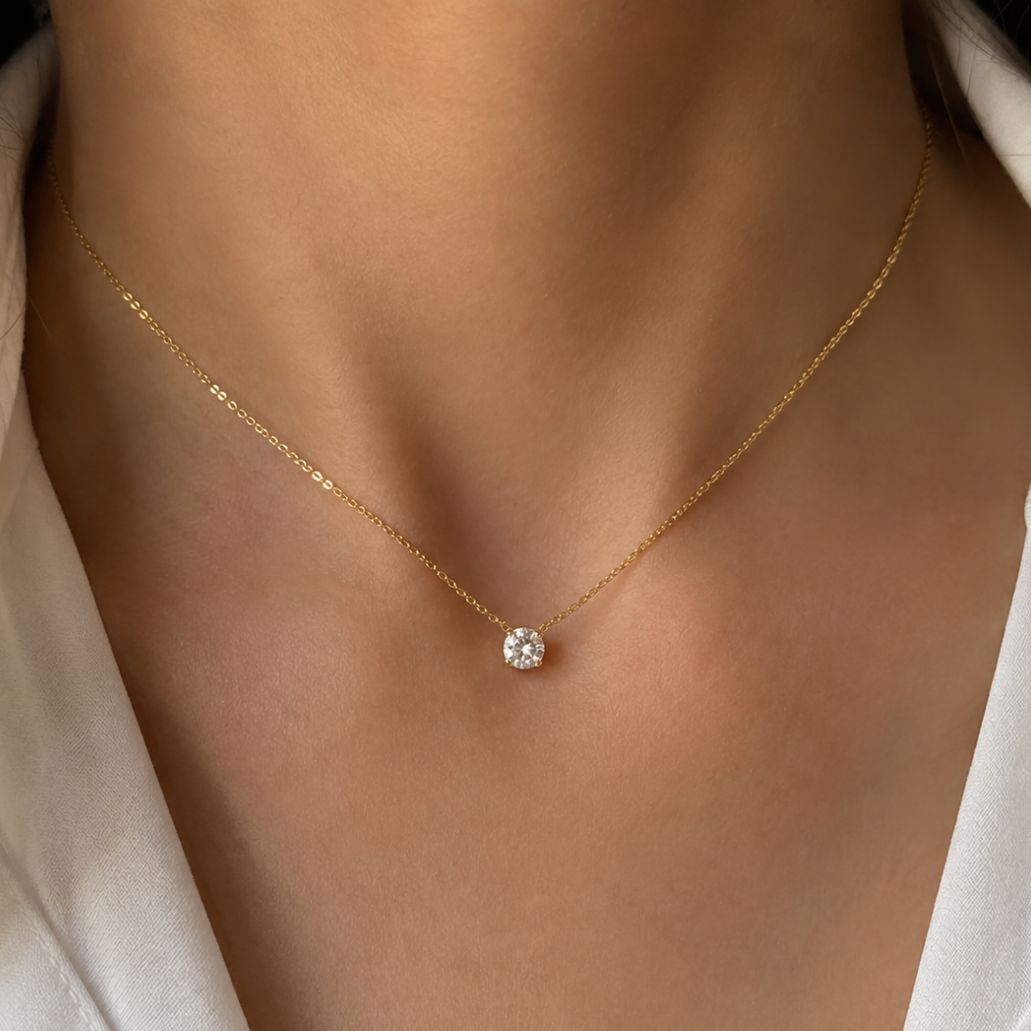 A round diamond necklace worn by a woman 