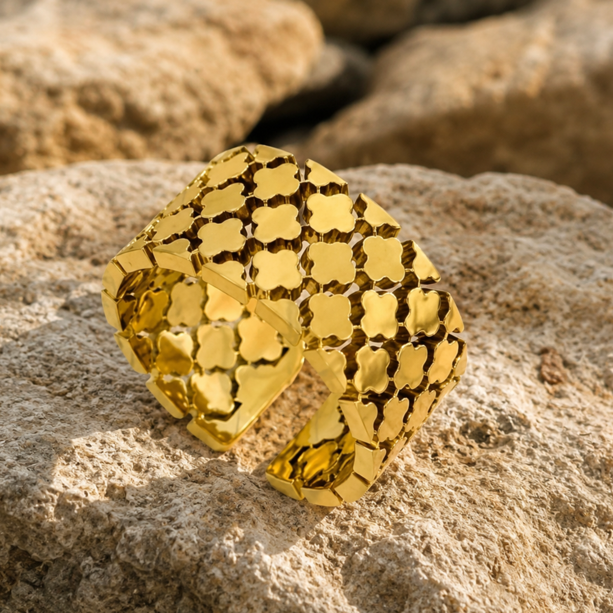 A chunky gold cuff ring on a rock