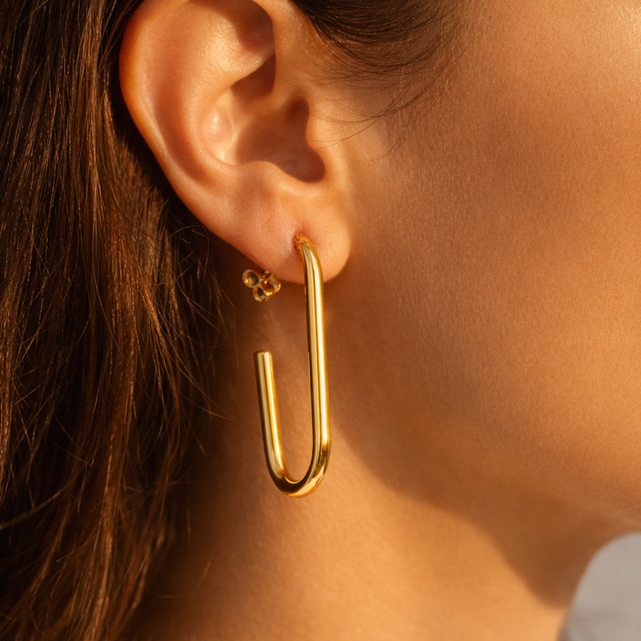 A woman wearing a gold hoop earring 