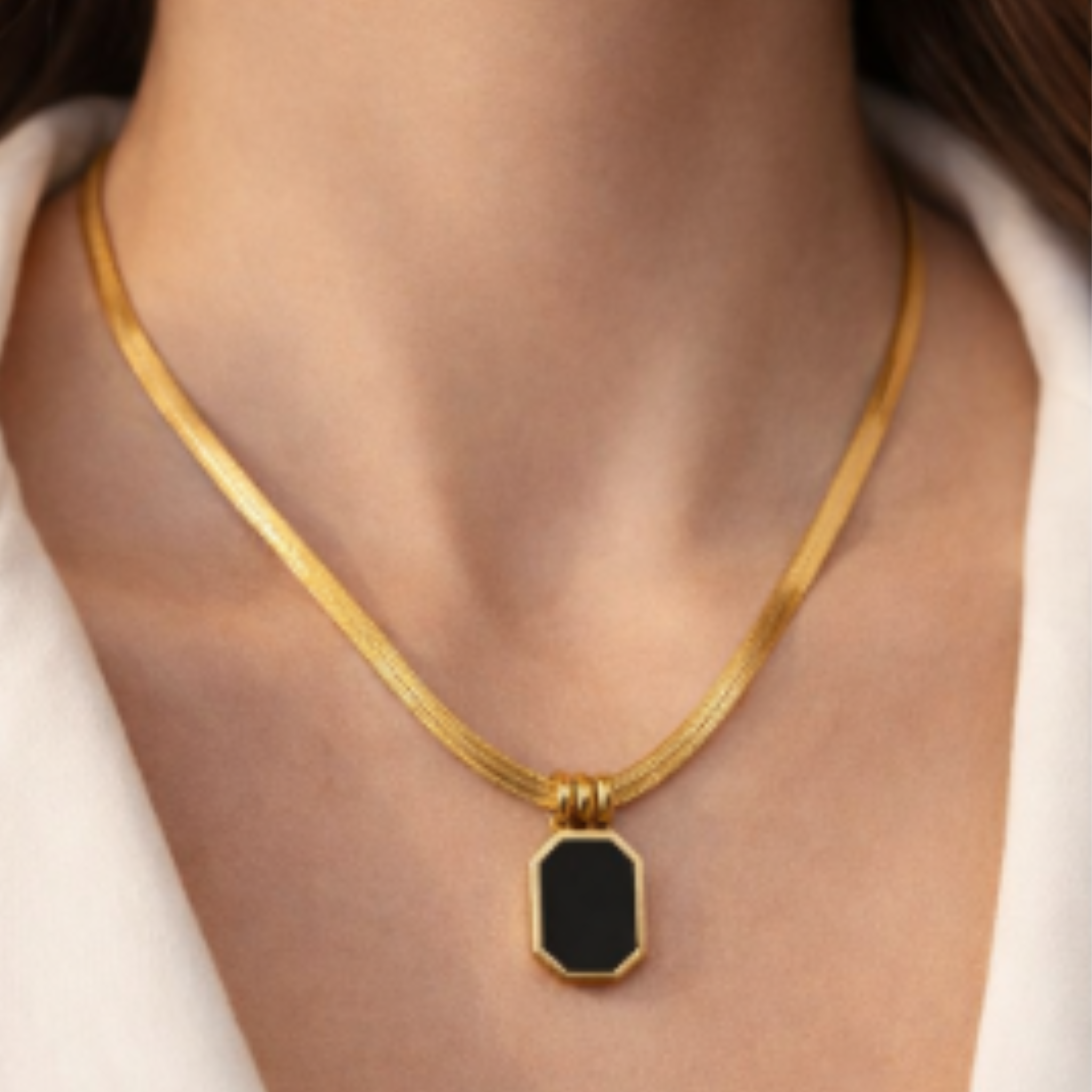 Woman wearing a black pendant necklace