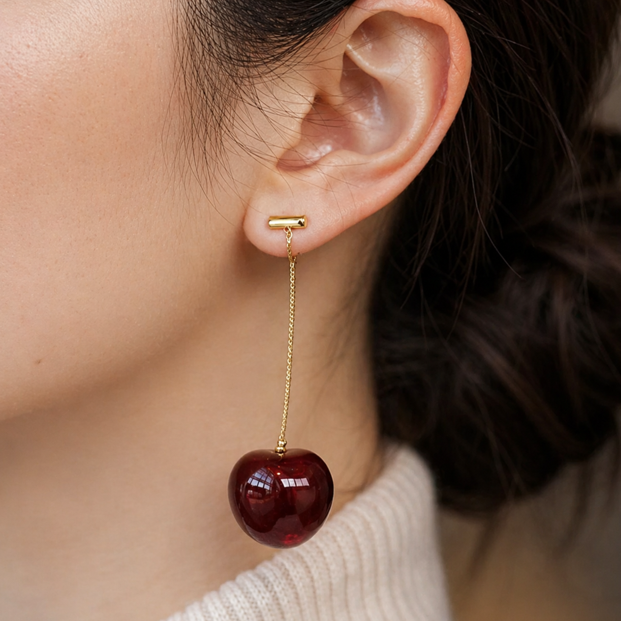 A woman wearing cherry-shaped earrings