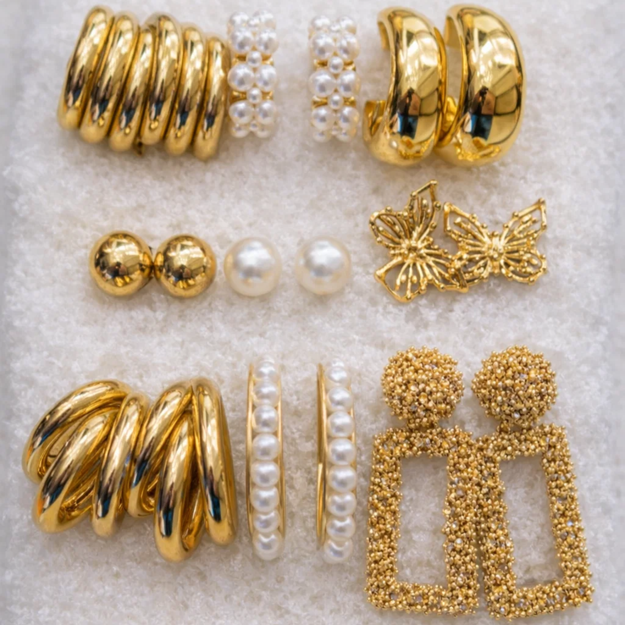 Set of casual earrings on a sponge surface