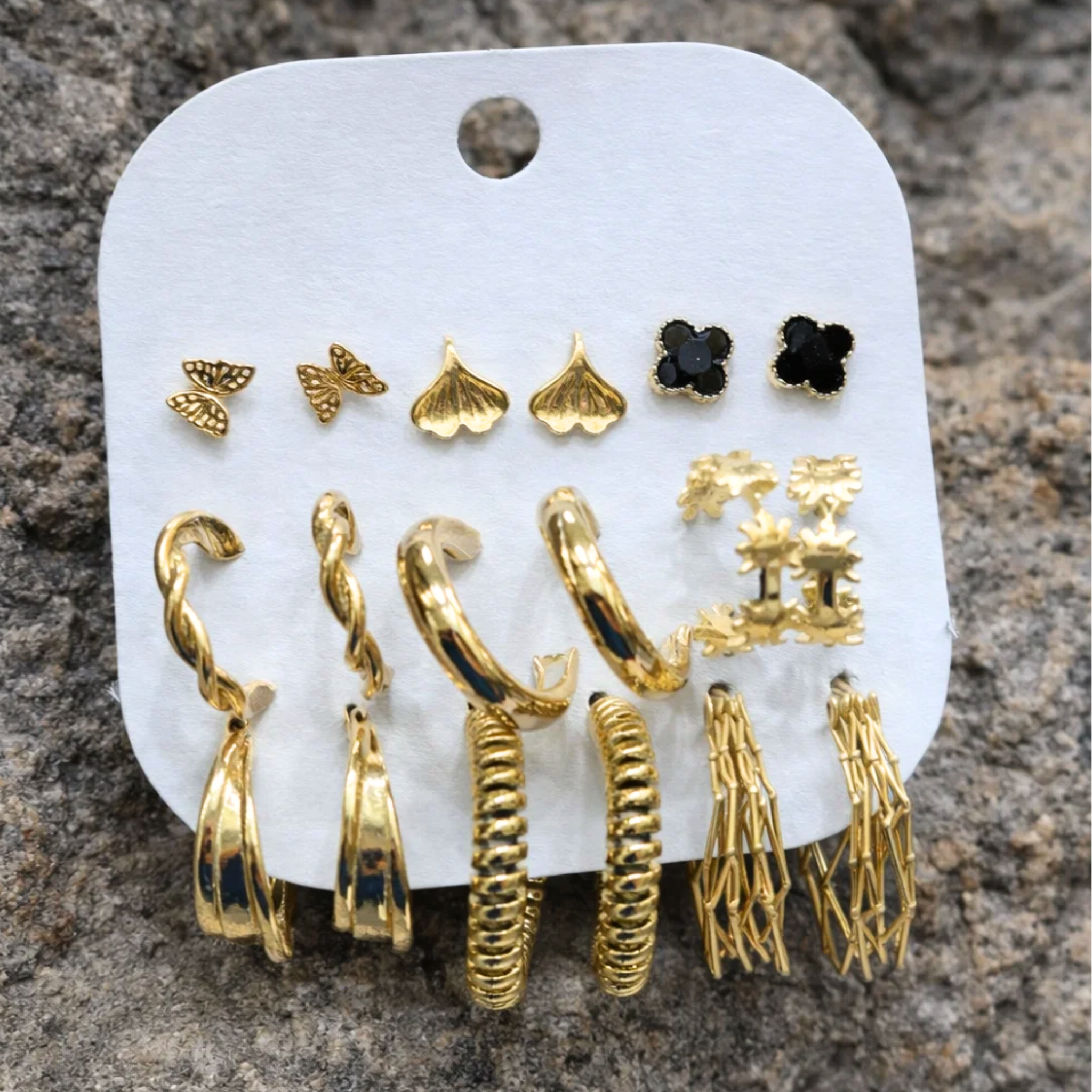 Set of casual earrings on a rock surface