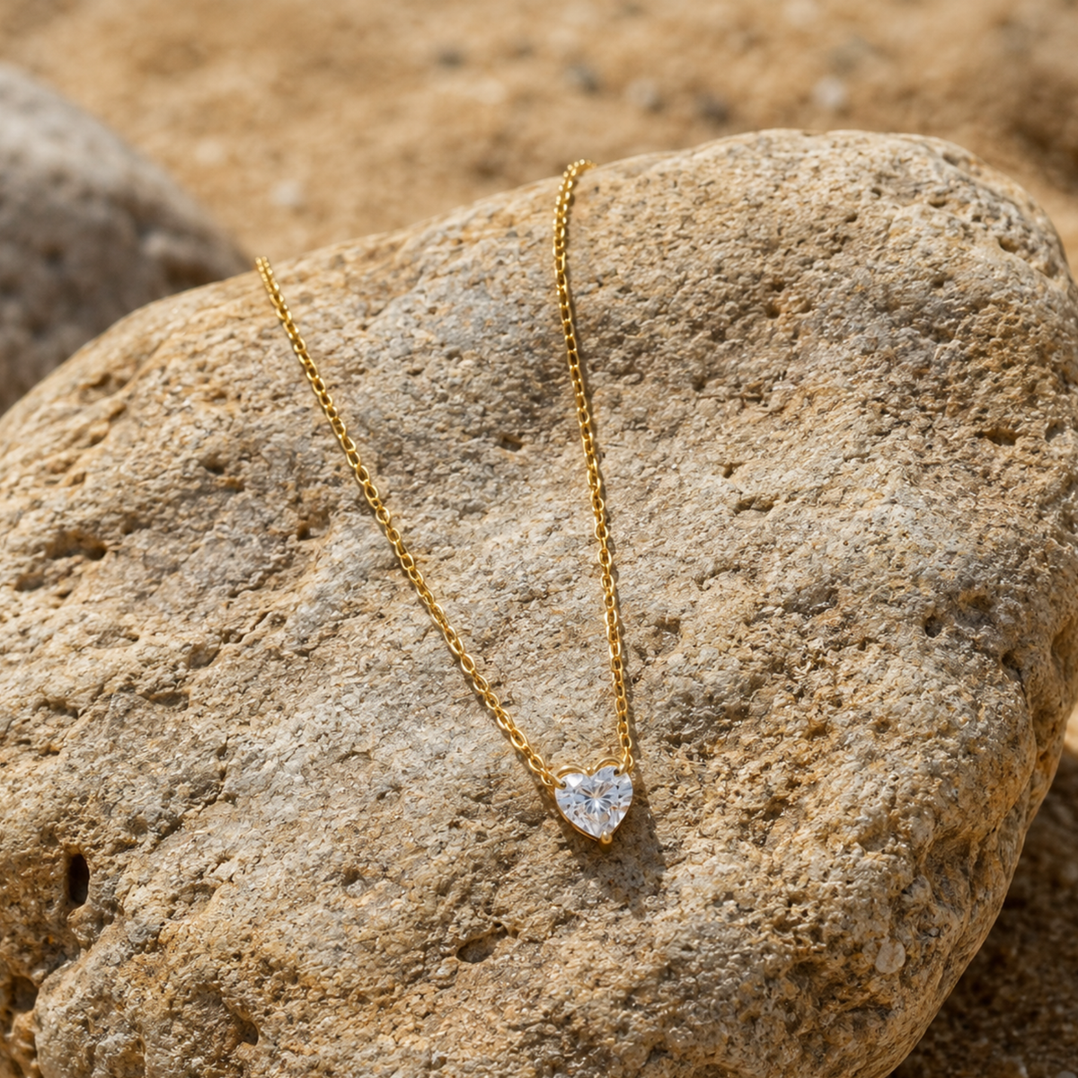 A minimalistic heart-shaped zircon pendant on a rock 