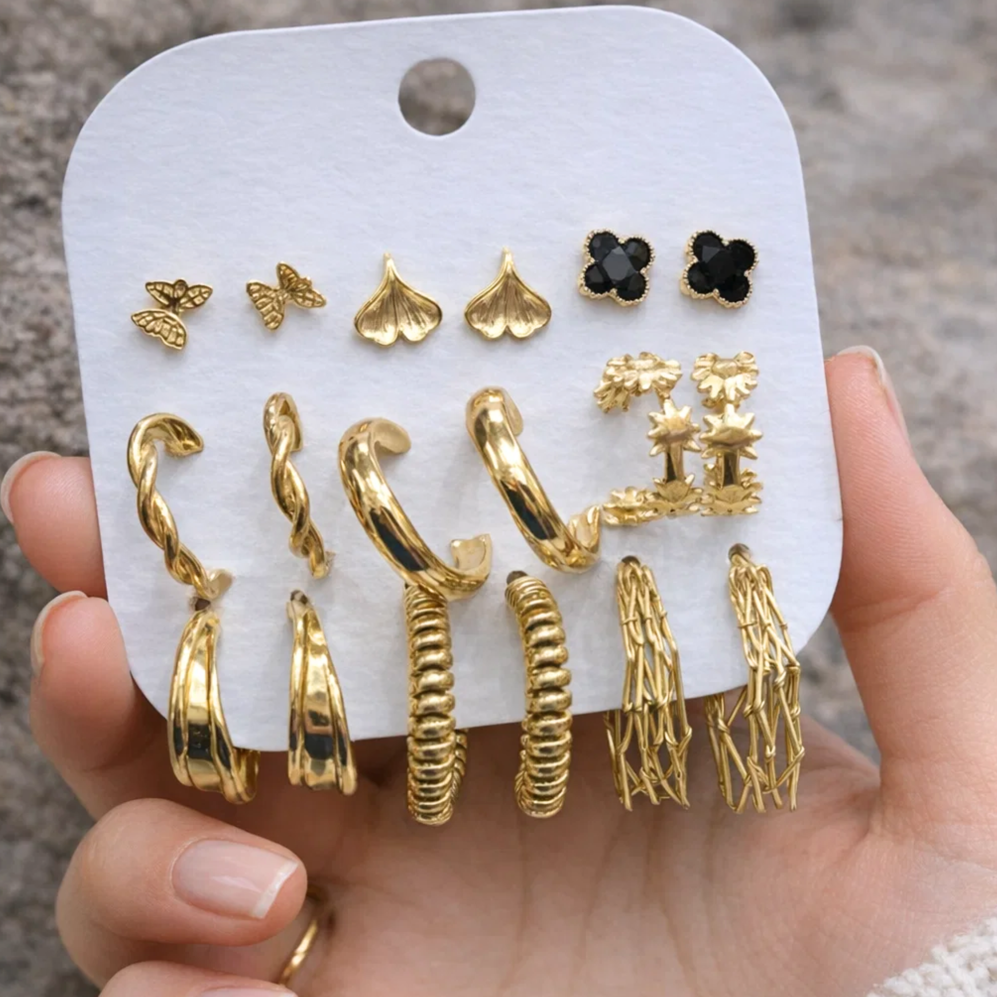 A woman holding a casual earring set