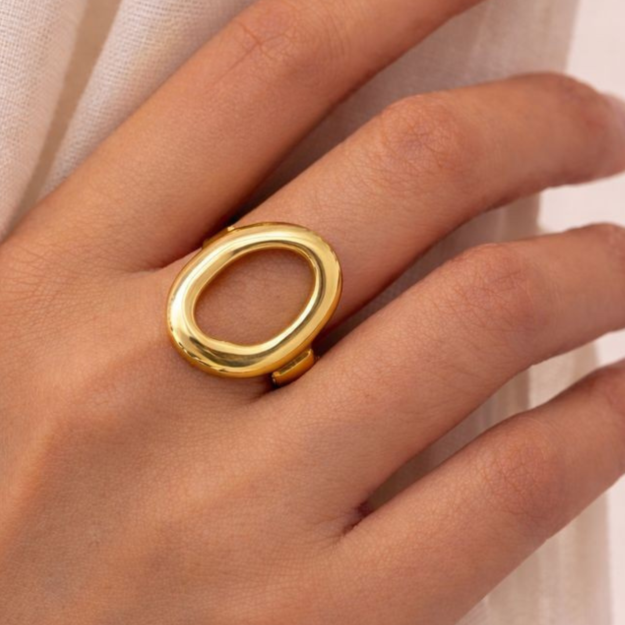 A woman wearing a circular statement ring