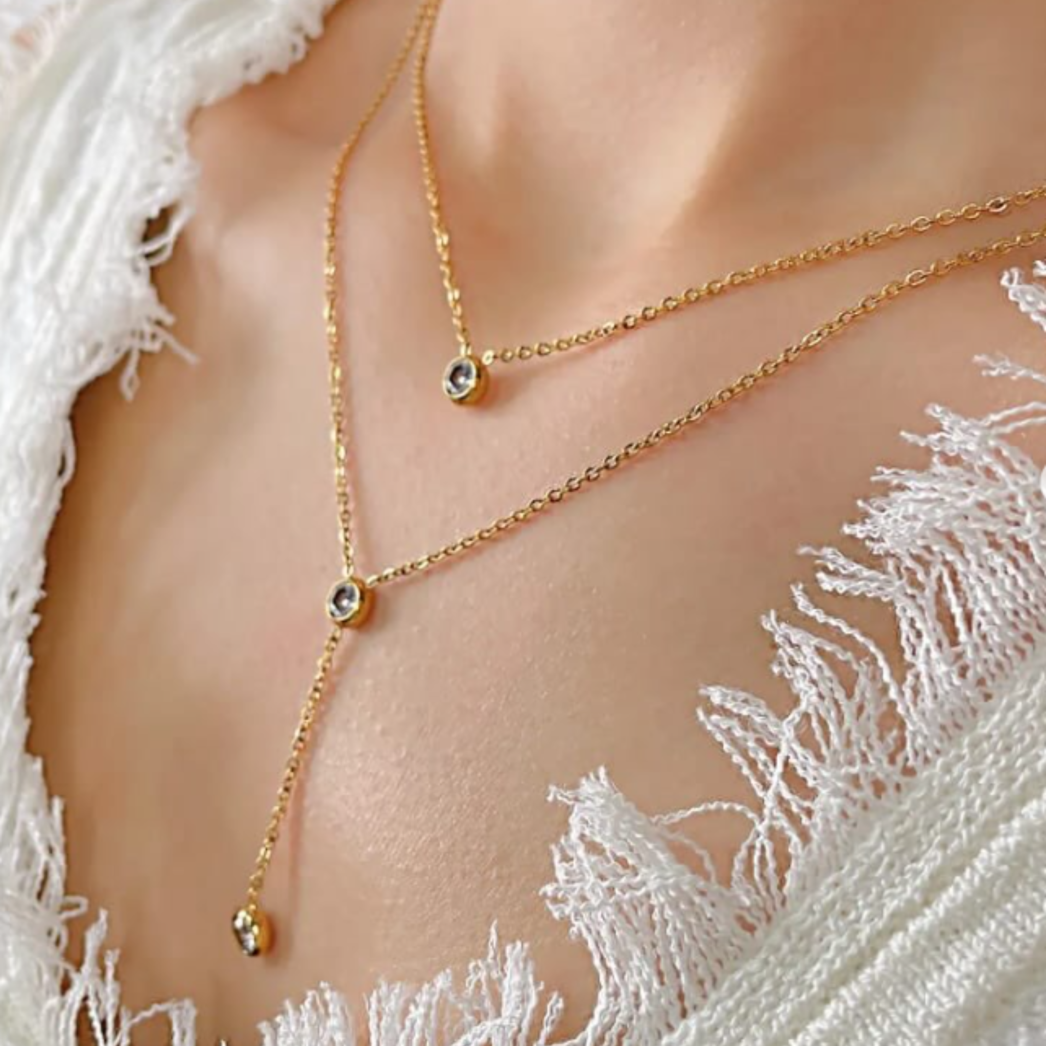 A woman wearing a double layer gold necklace