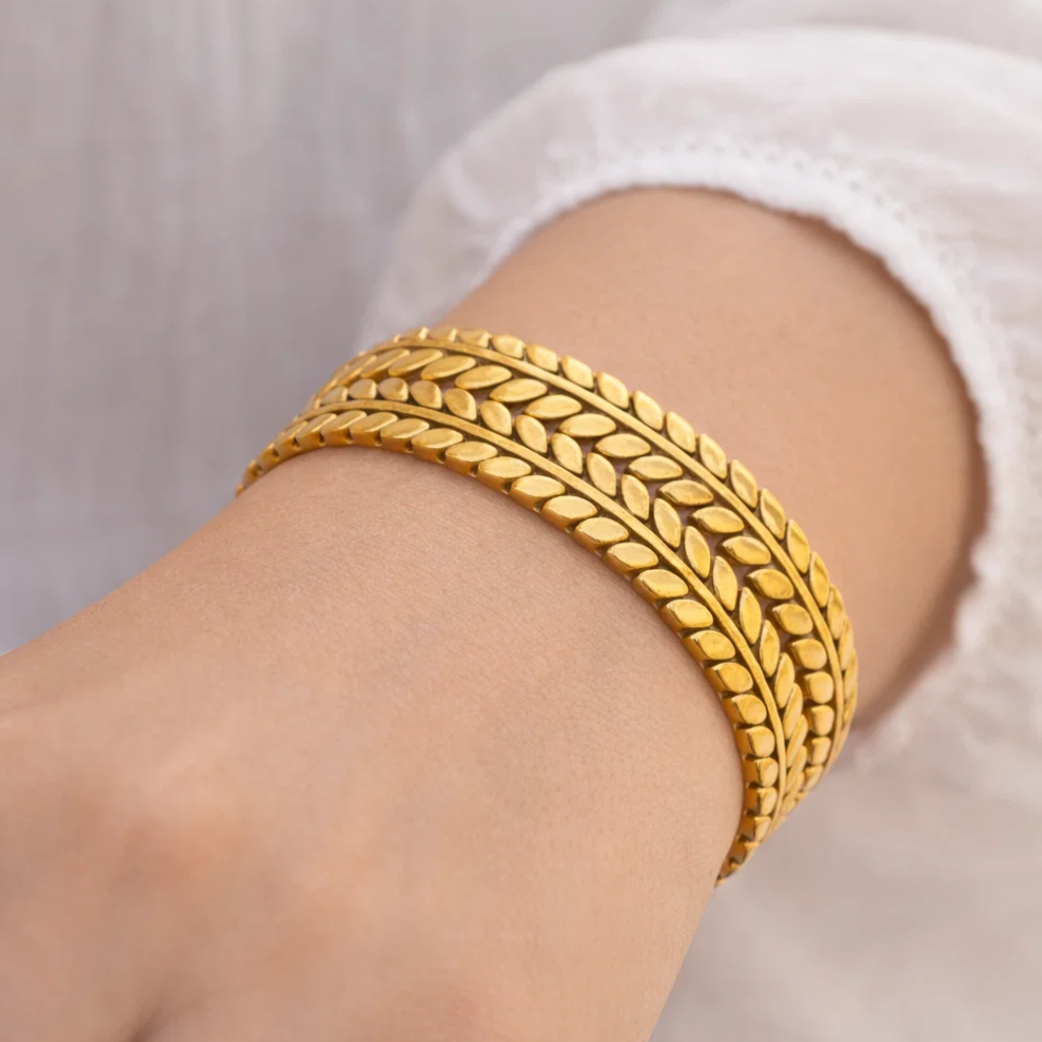 A woman wearing a double leaf cuff bangle