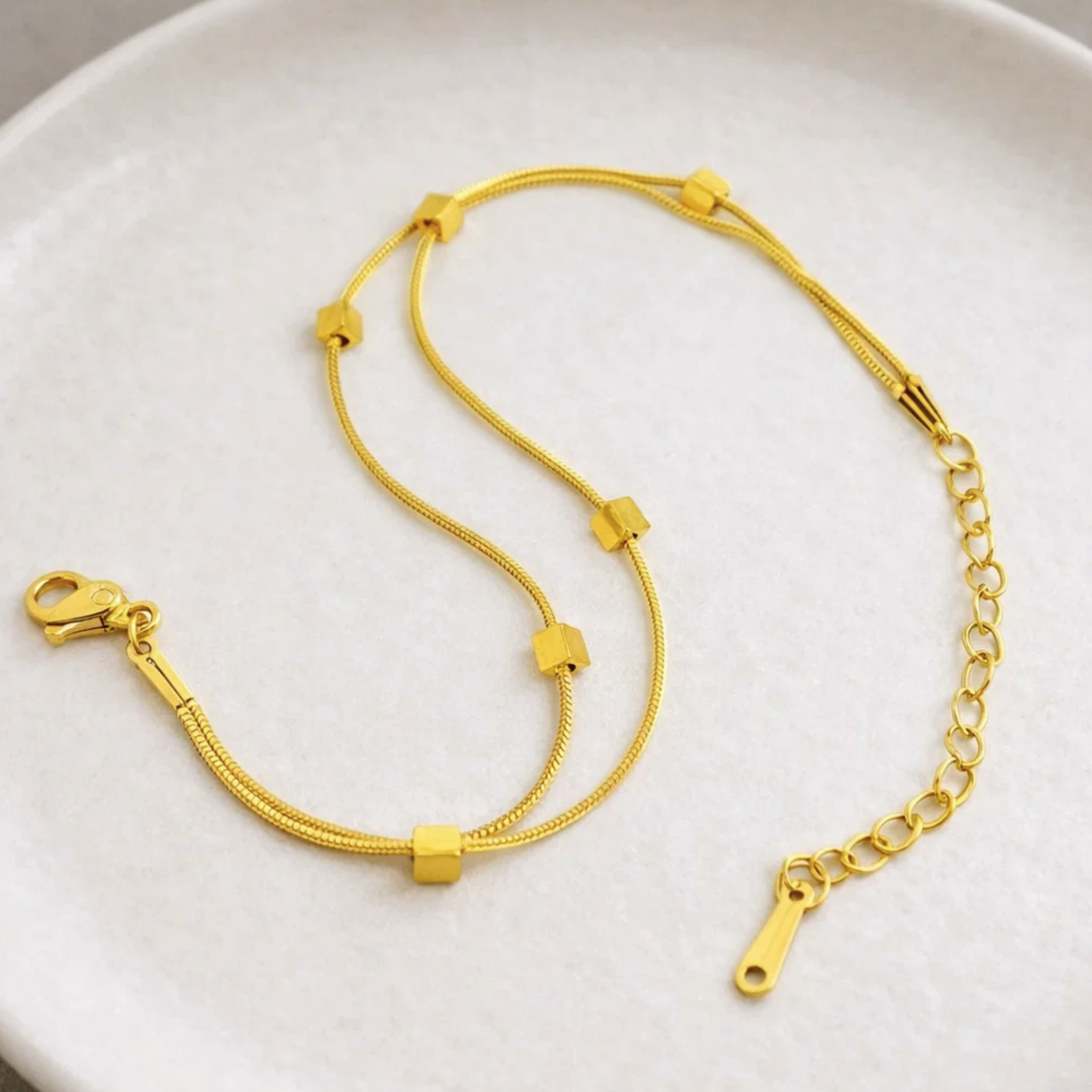 Double stranded bracelet on a ceramic plate