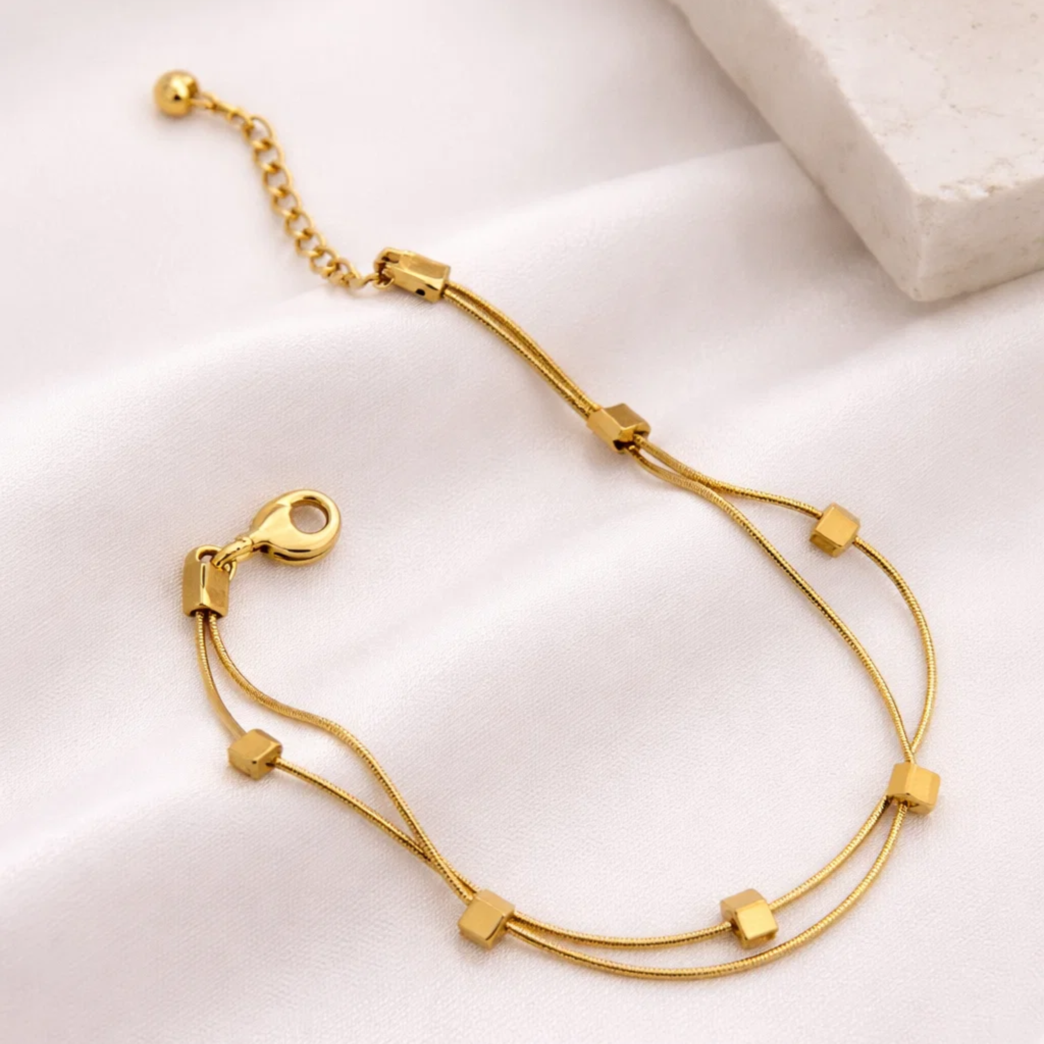Gold bracelet on a white surface