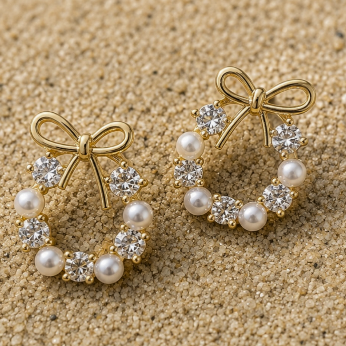 A dangle earrings with pearls and gemstones on it