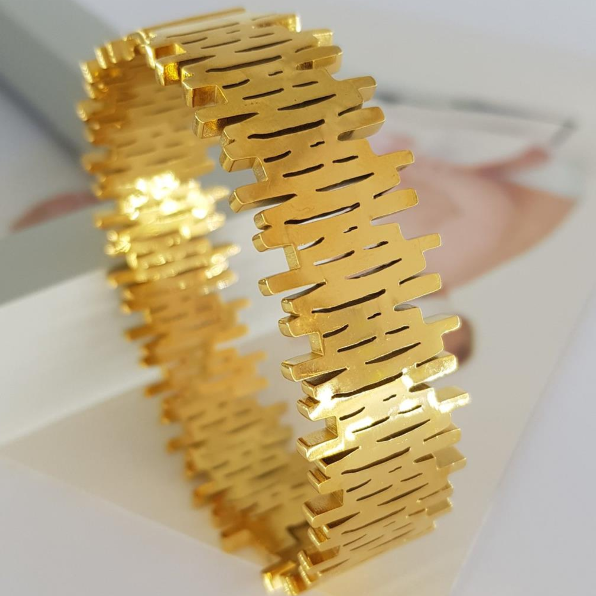 Gold bangle with a textured design 
