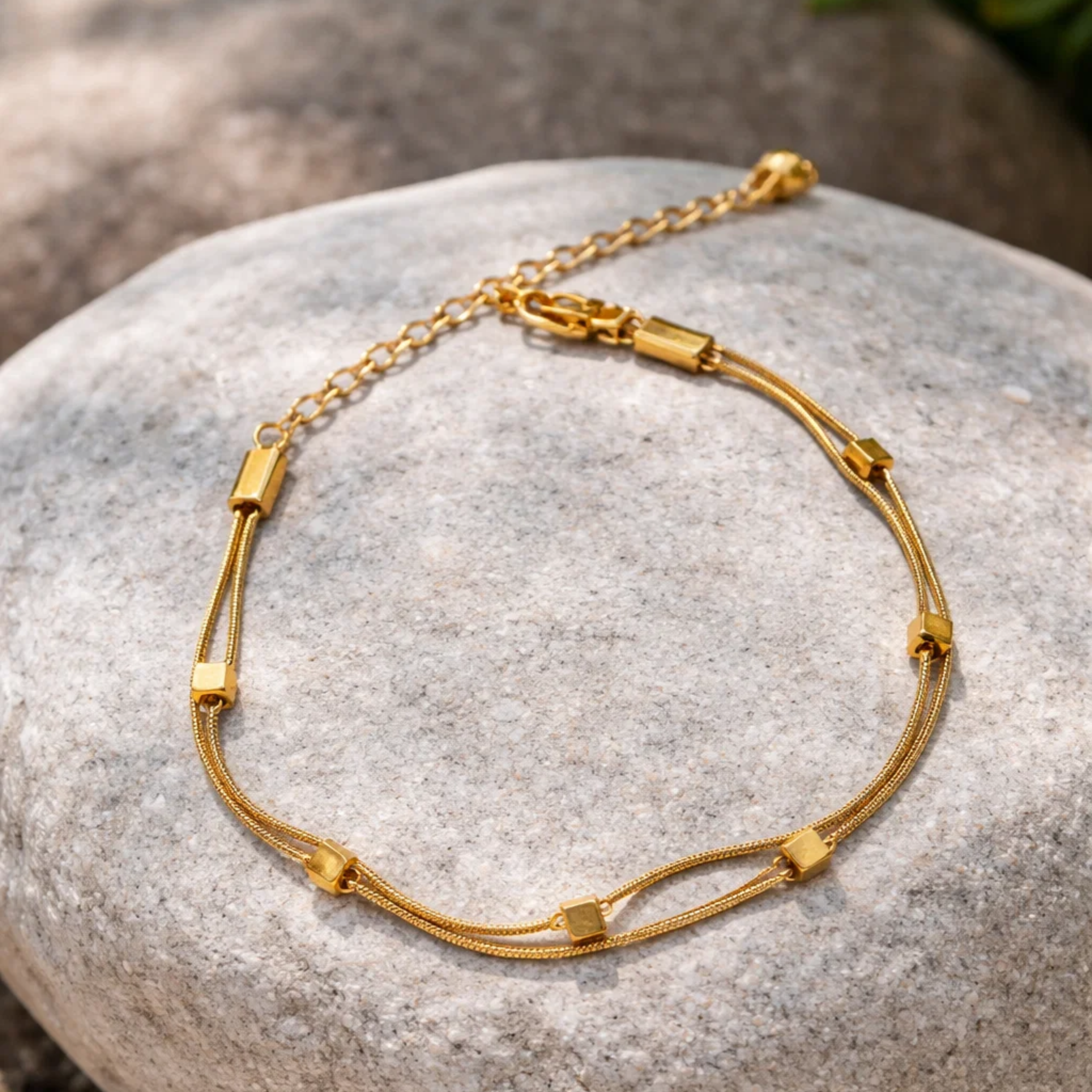 Gold bracelet on a stone surface