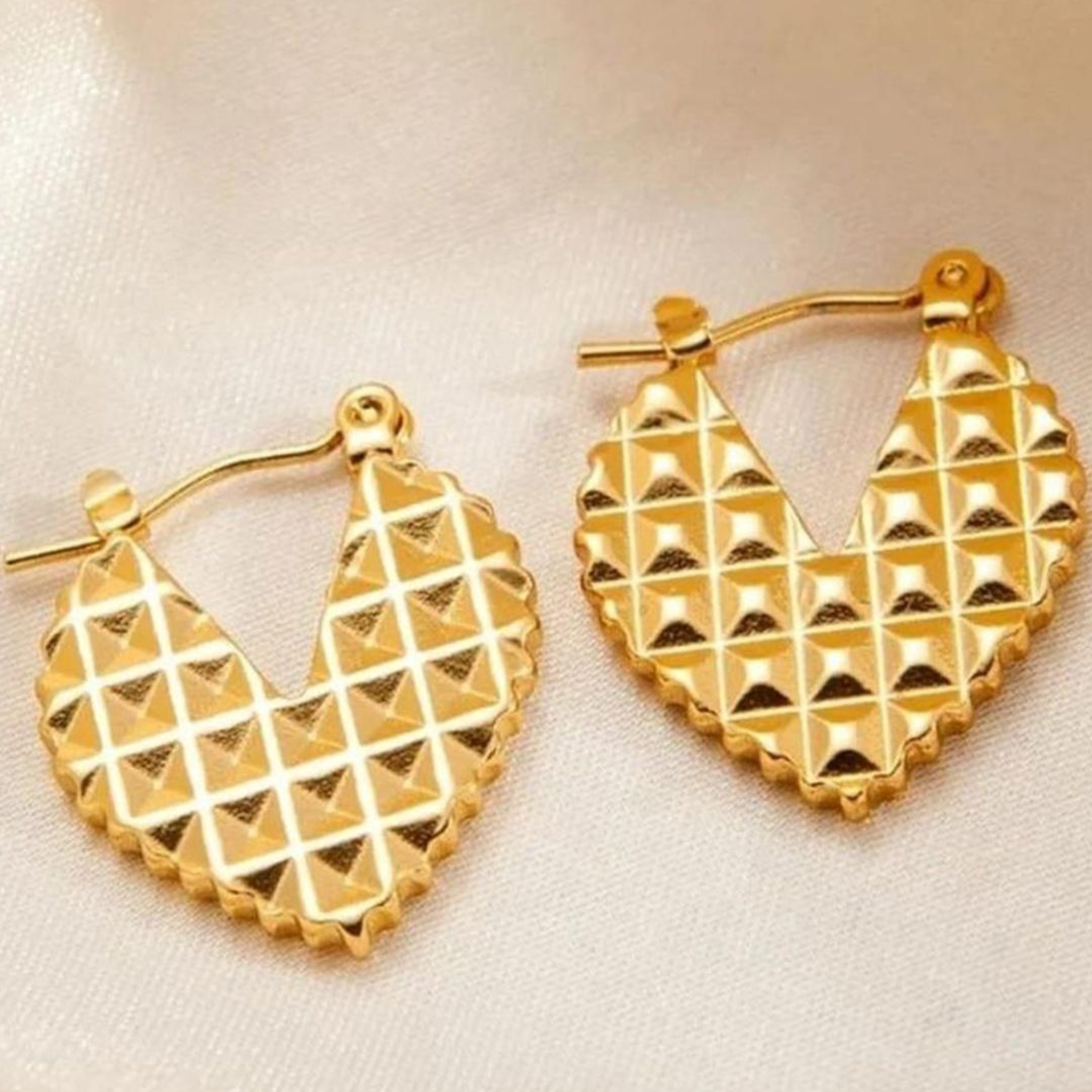 Gold hoop earrings with a textured pattern 
