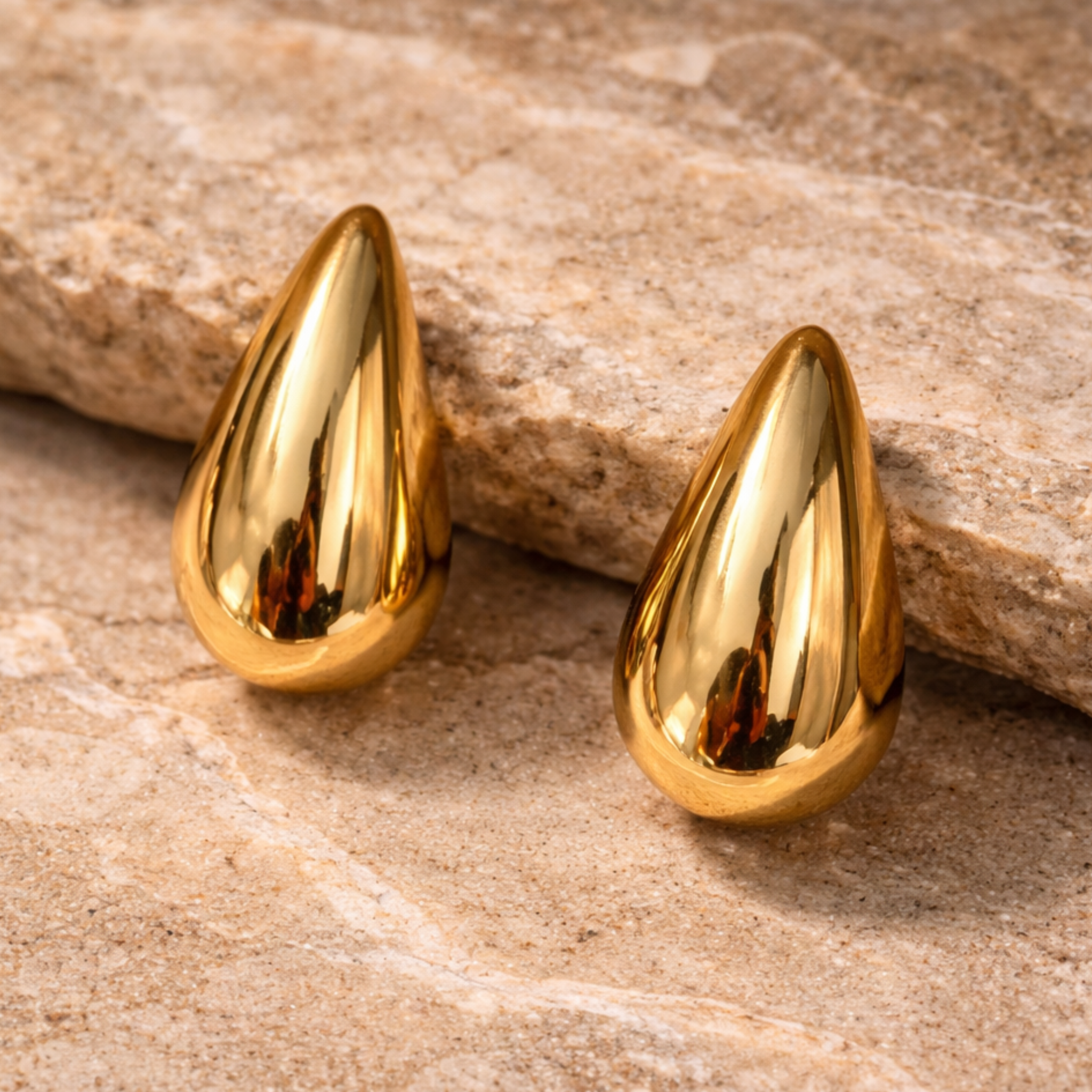 Teardrop earrings on a rock
