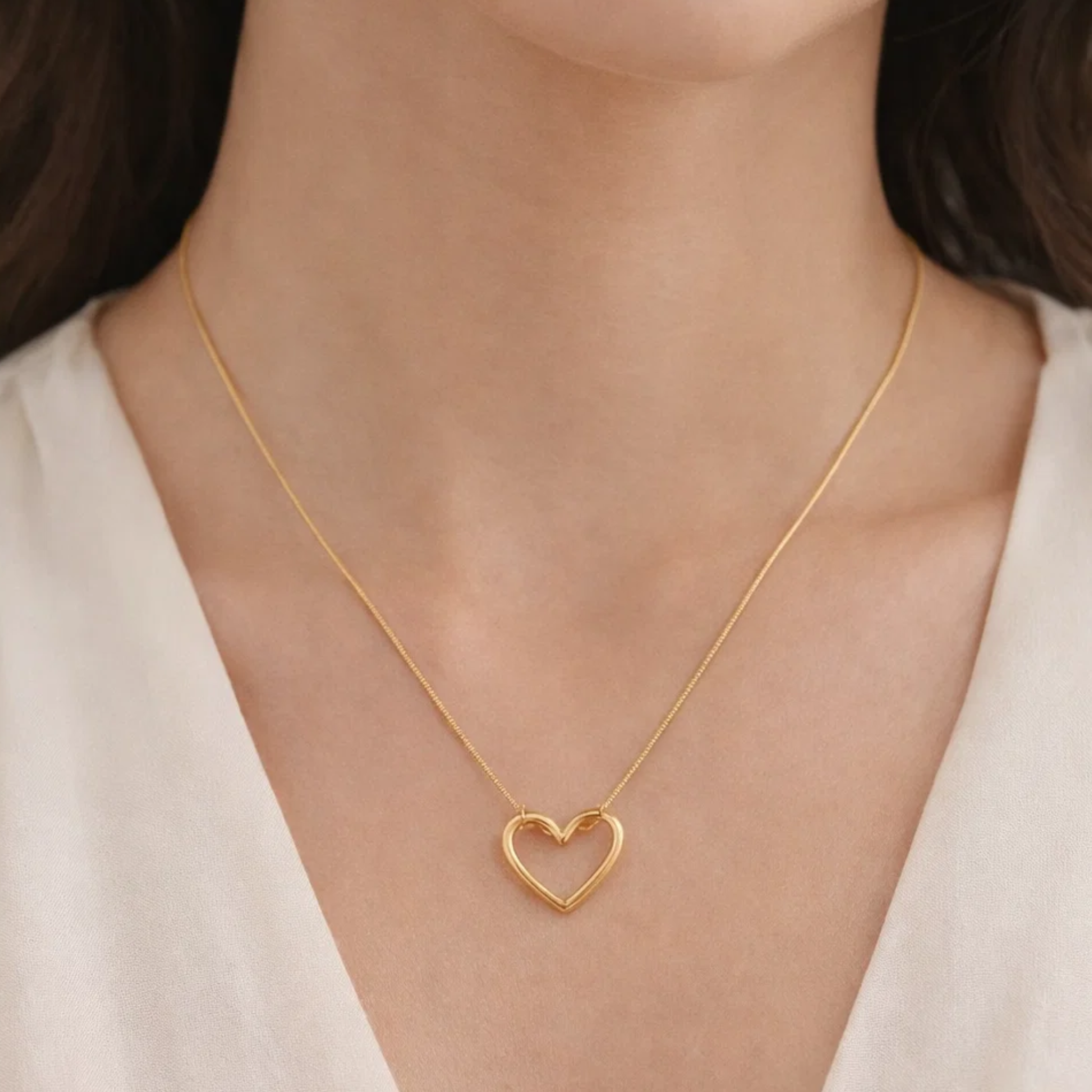 A woman wearing a heart-shaped necklace