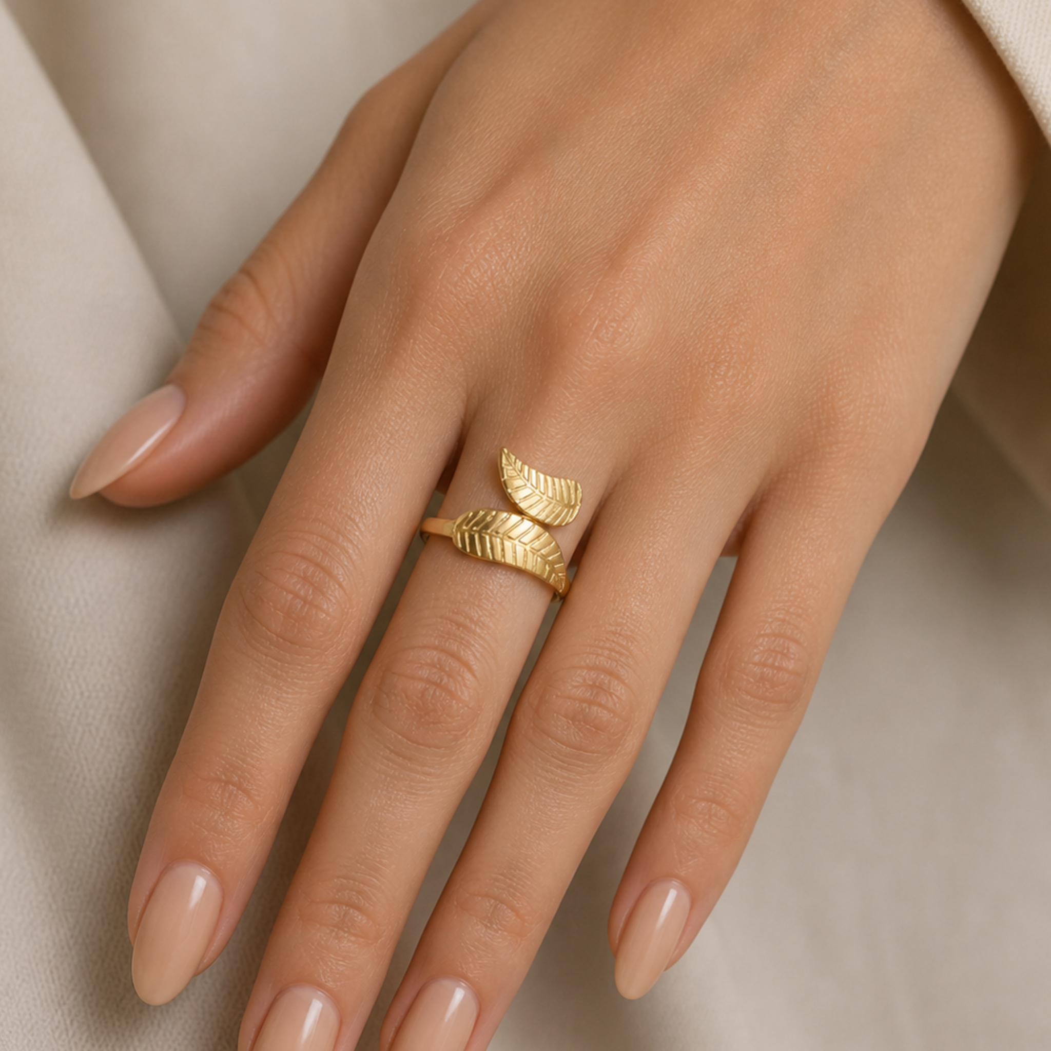 A woman wearing a gold leaf ring