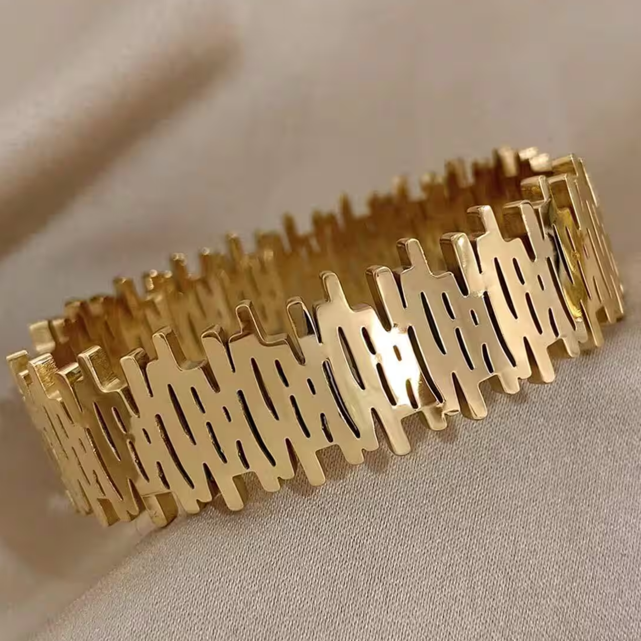 Gold bangle on a beige background