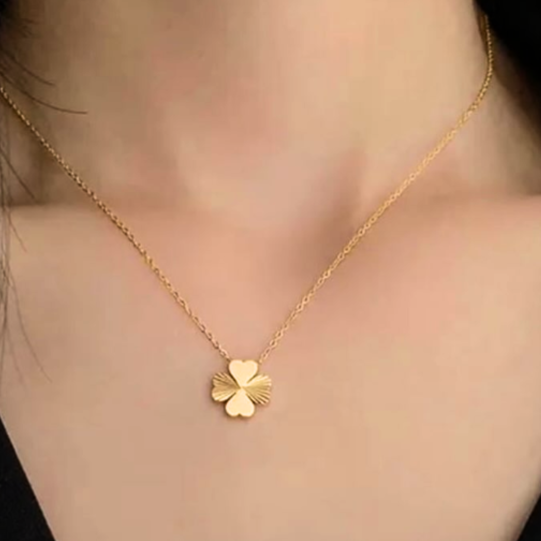 A woman wearing a clover necklace