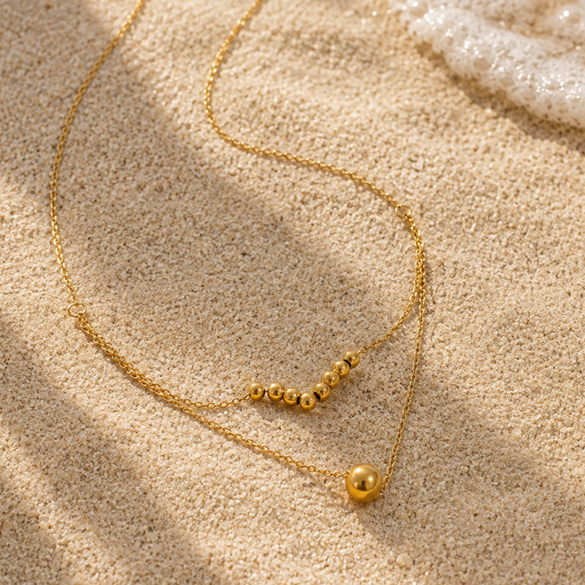 Beaded necklace on a sand surface 