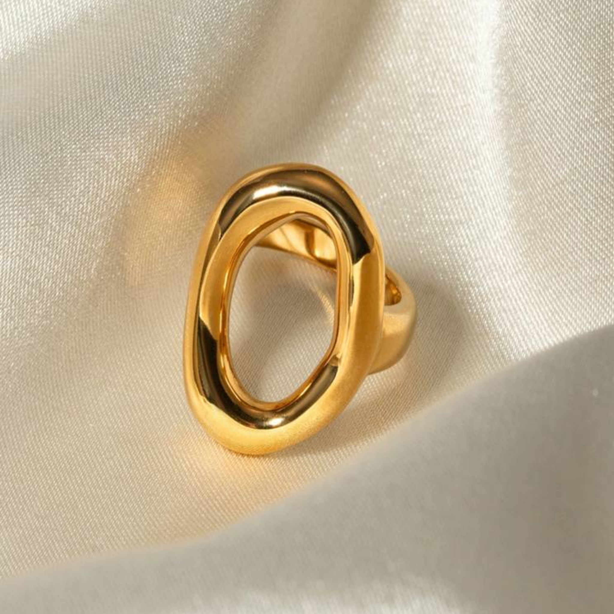 A sculptural oval ring on a silk fabric