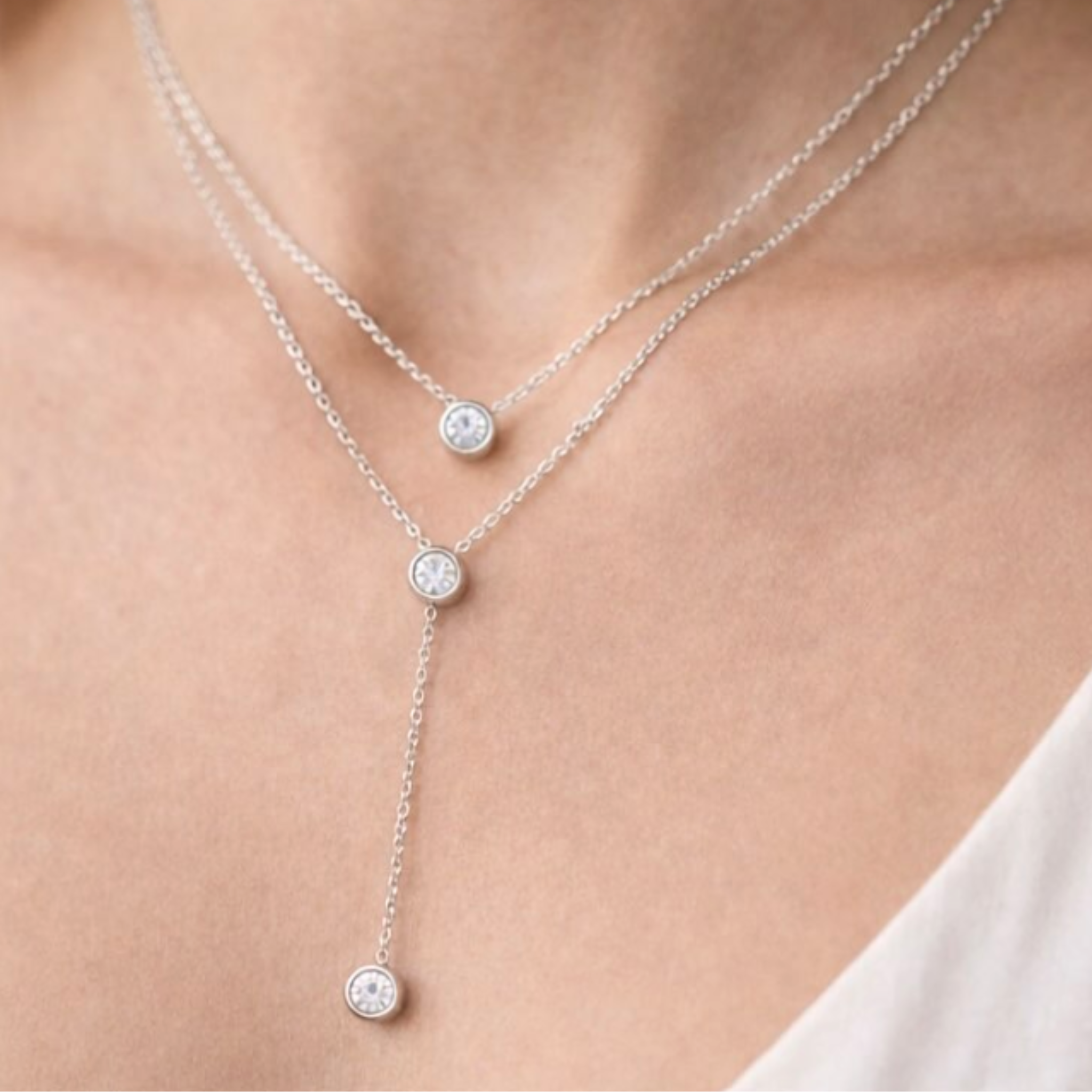 A woman wearing a silver double layer necklace