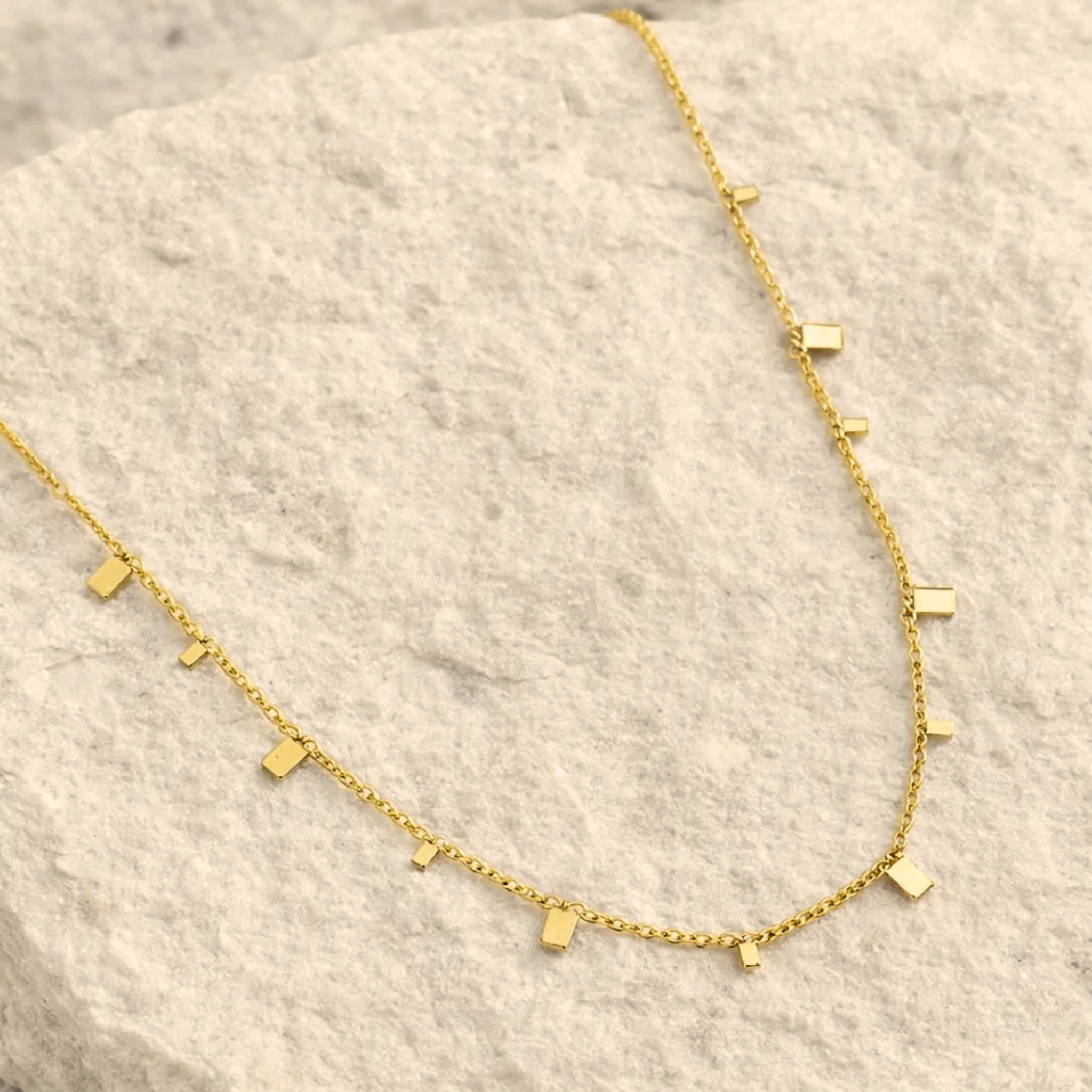 Gold necklace with small rectangle pendants 