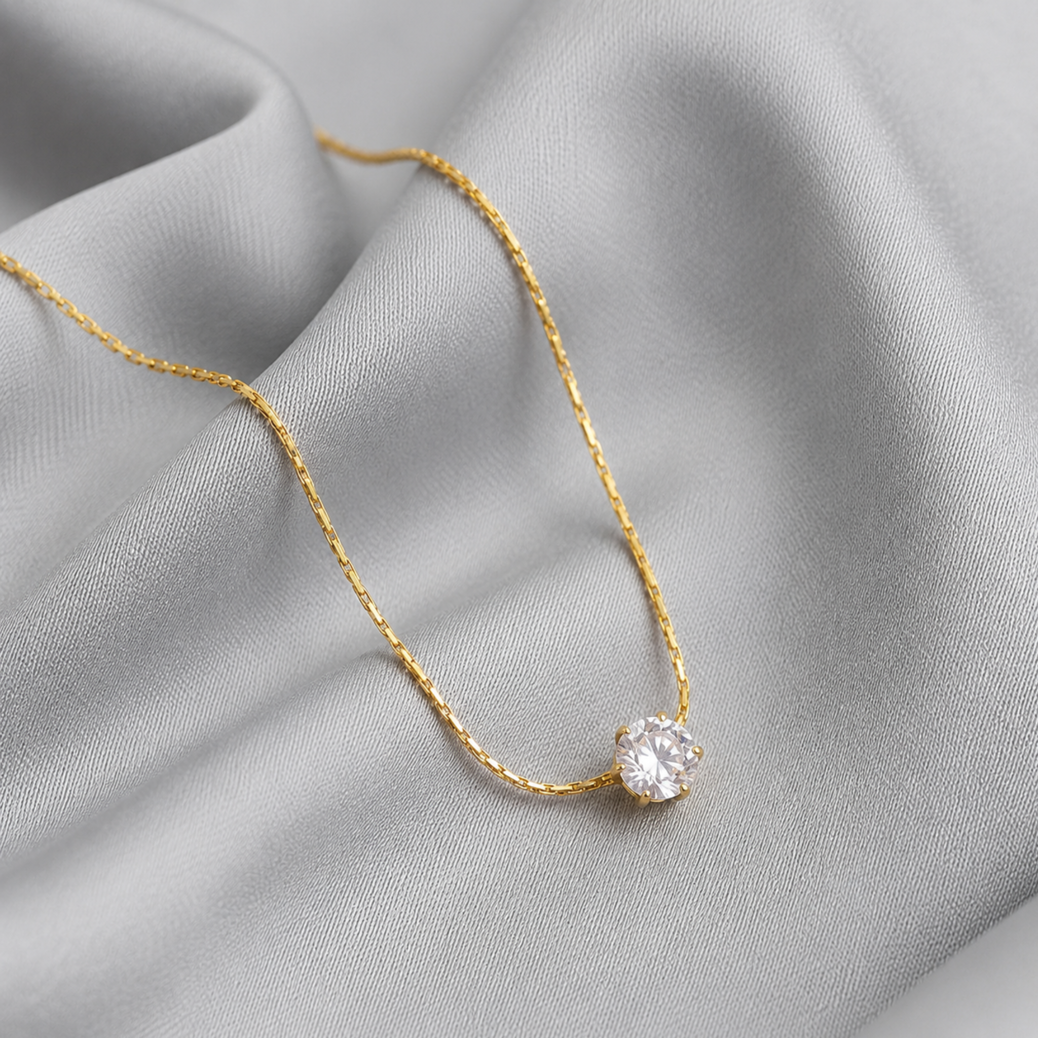 A solitaire minimalistic necklace on a silk cloth