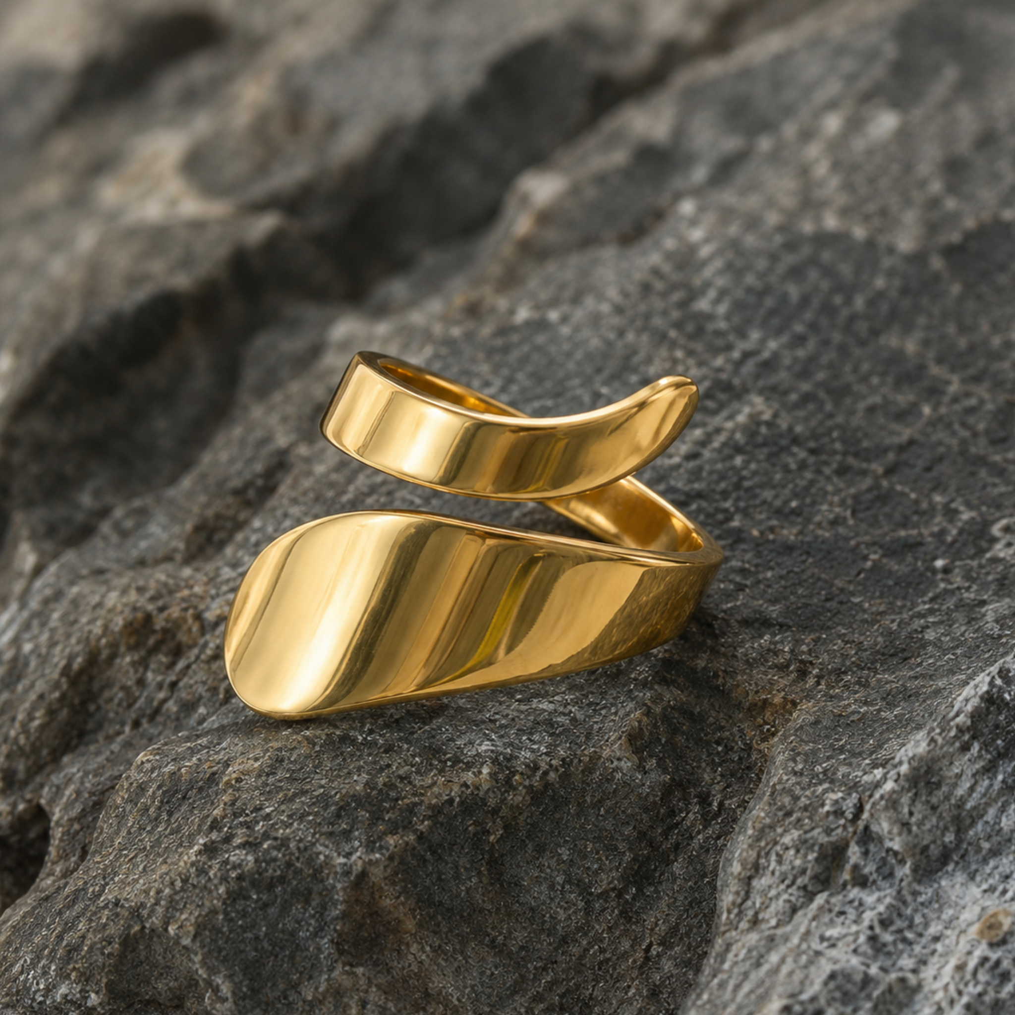 A spiral gold ring on a rock background