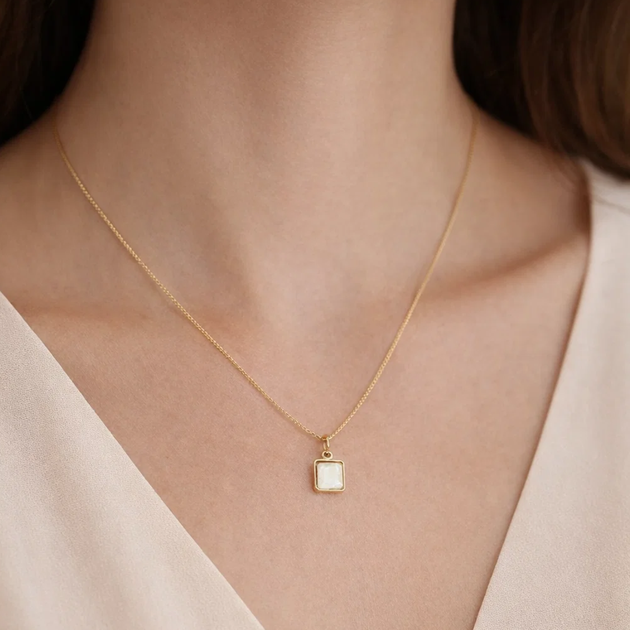 A woman wearing a white shell pendant necklace