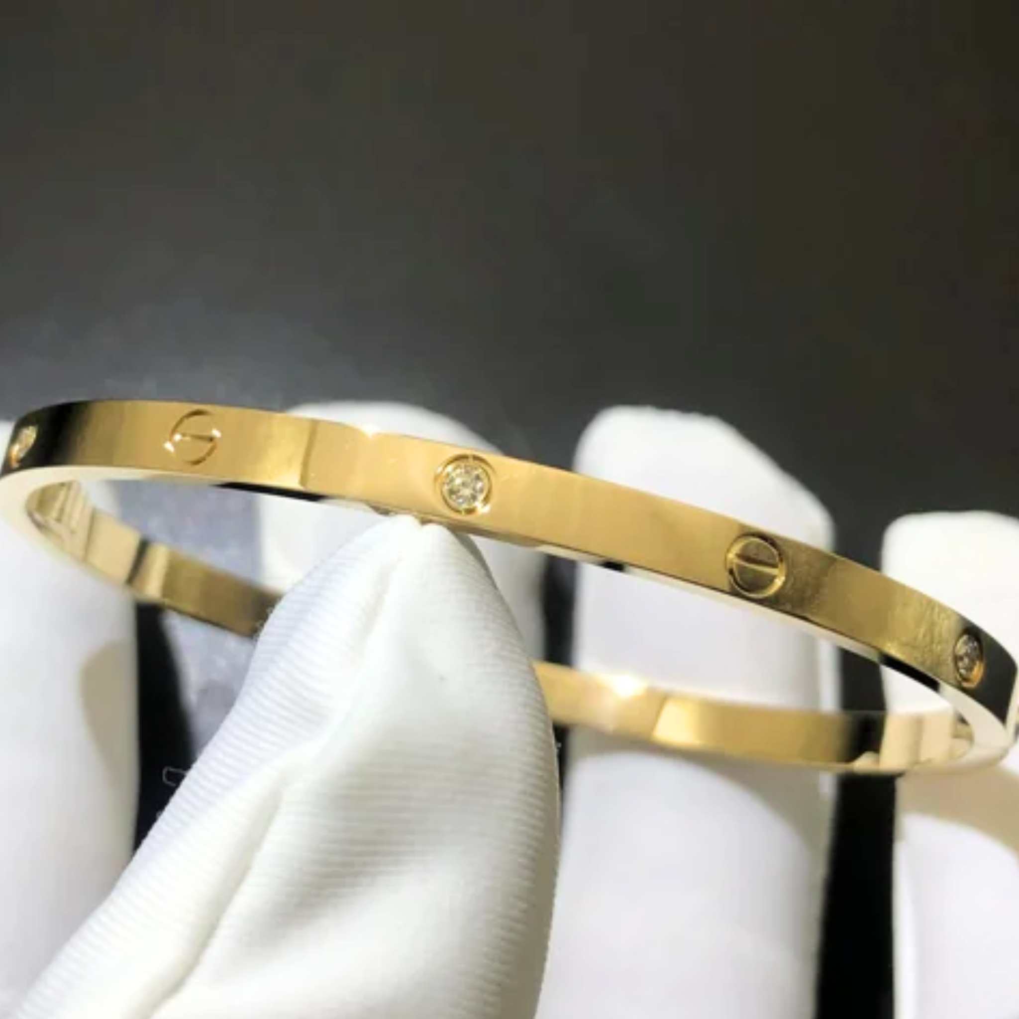 A person holding a Cartier bangle