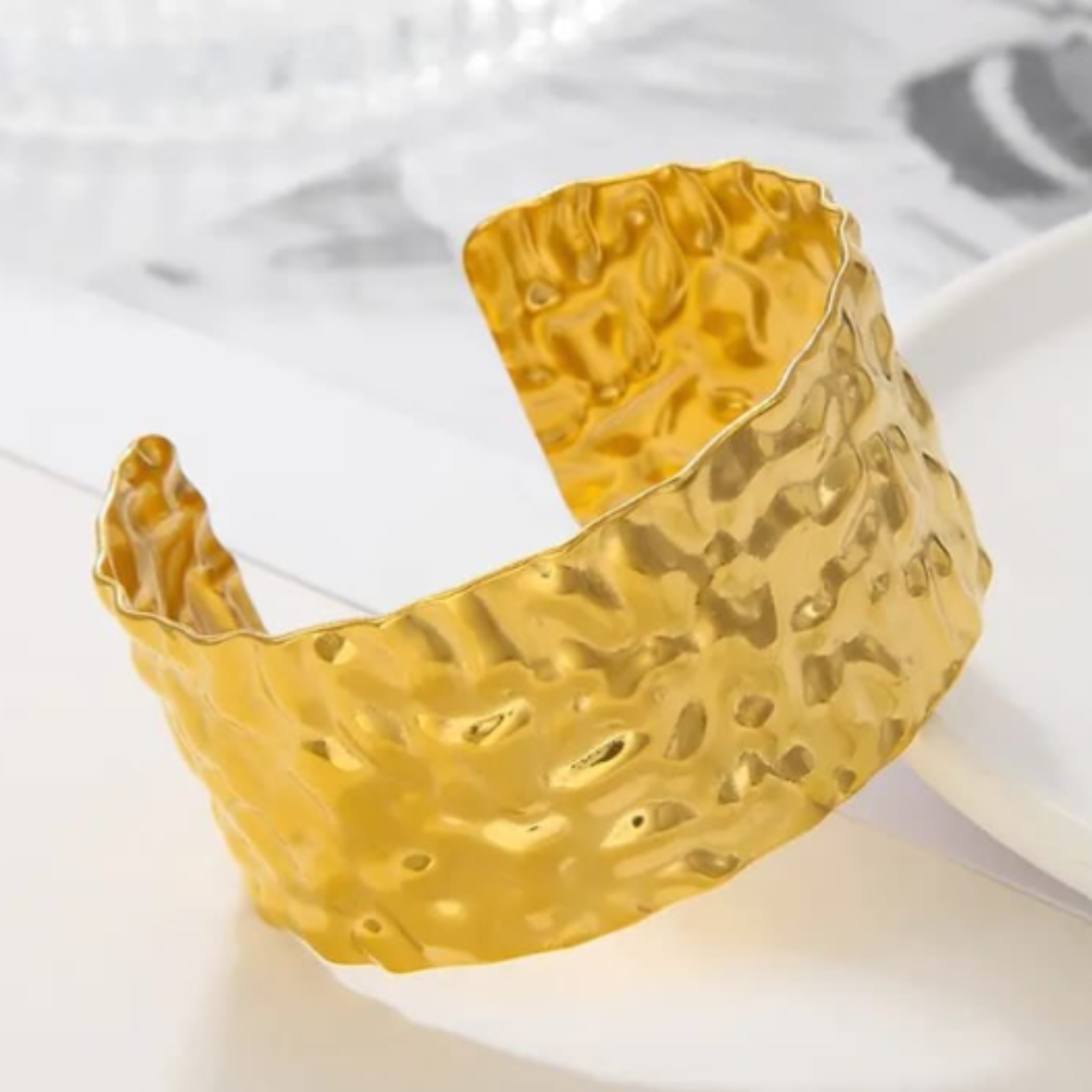 Gold cuff bangle with a hammered texture