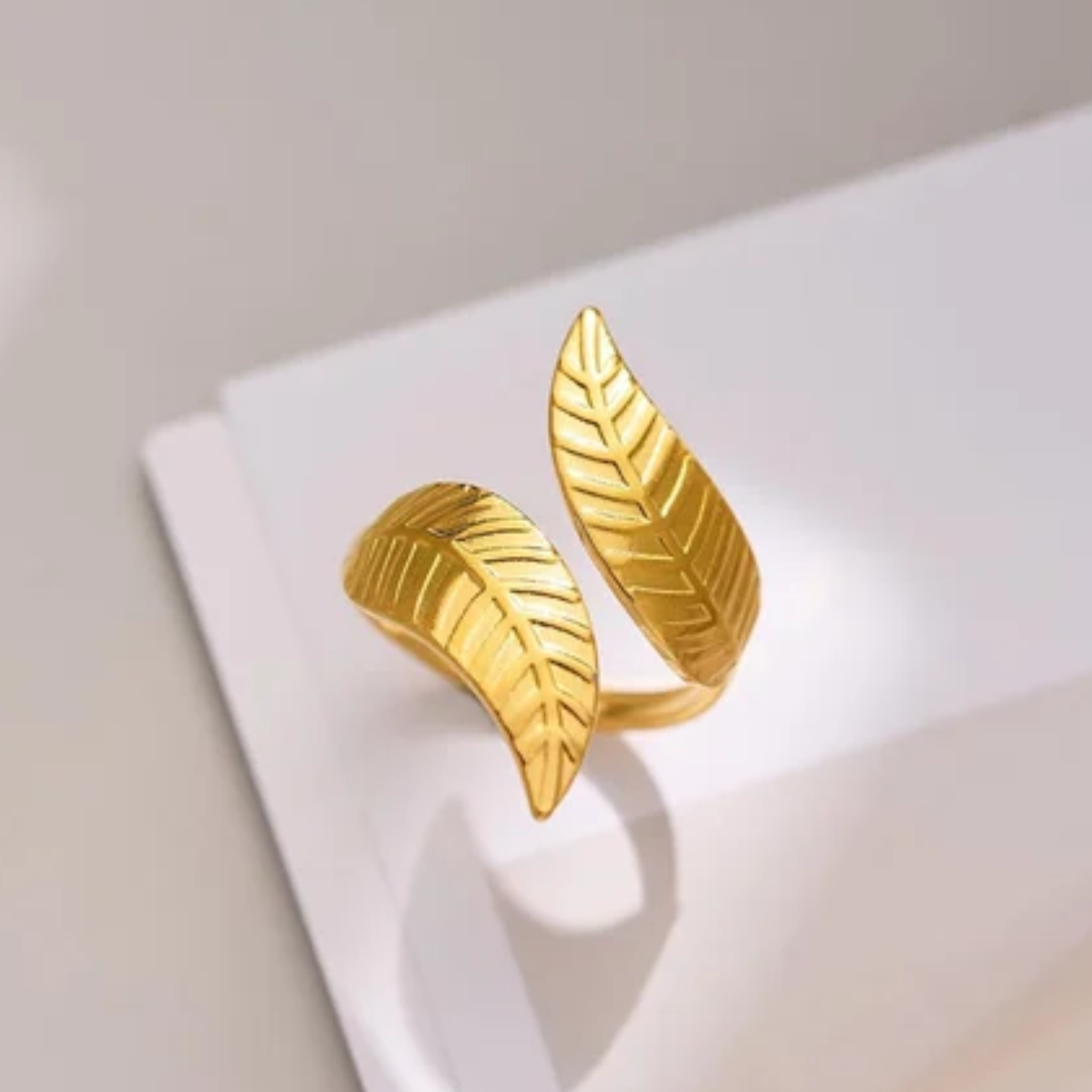 A minimalistic gold ring having leaf shape