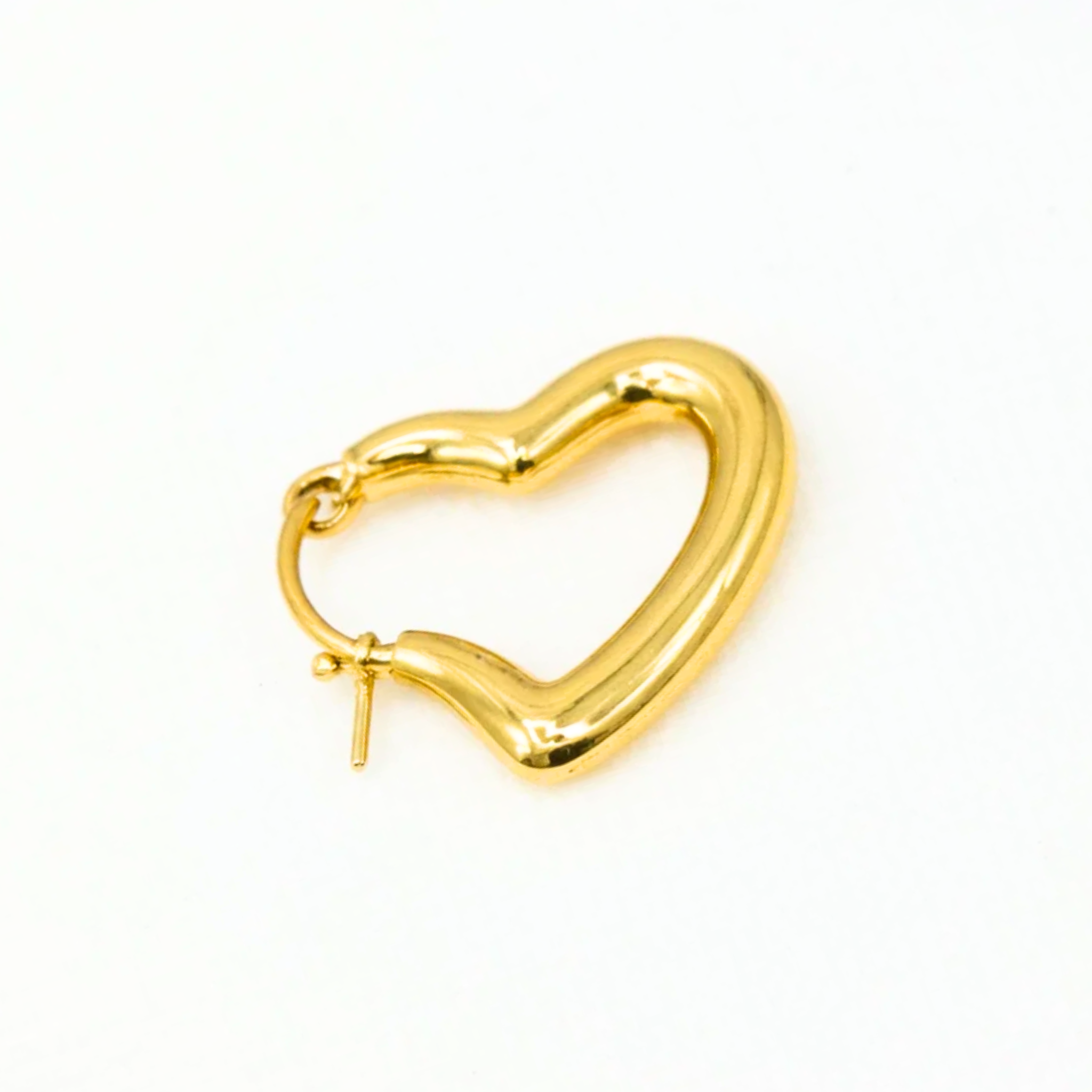 Gold heart-shaped hoop earring on a white background