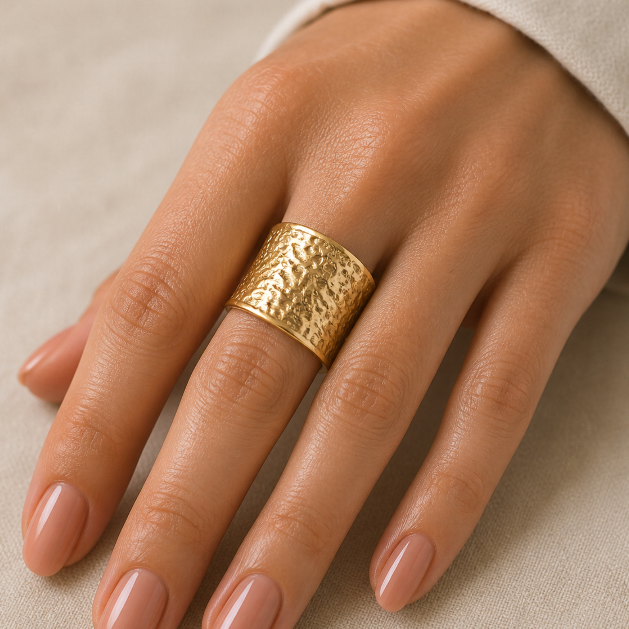 A woman wearing a textured gold ring