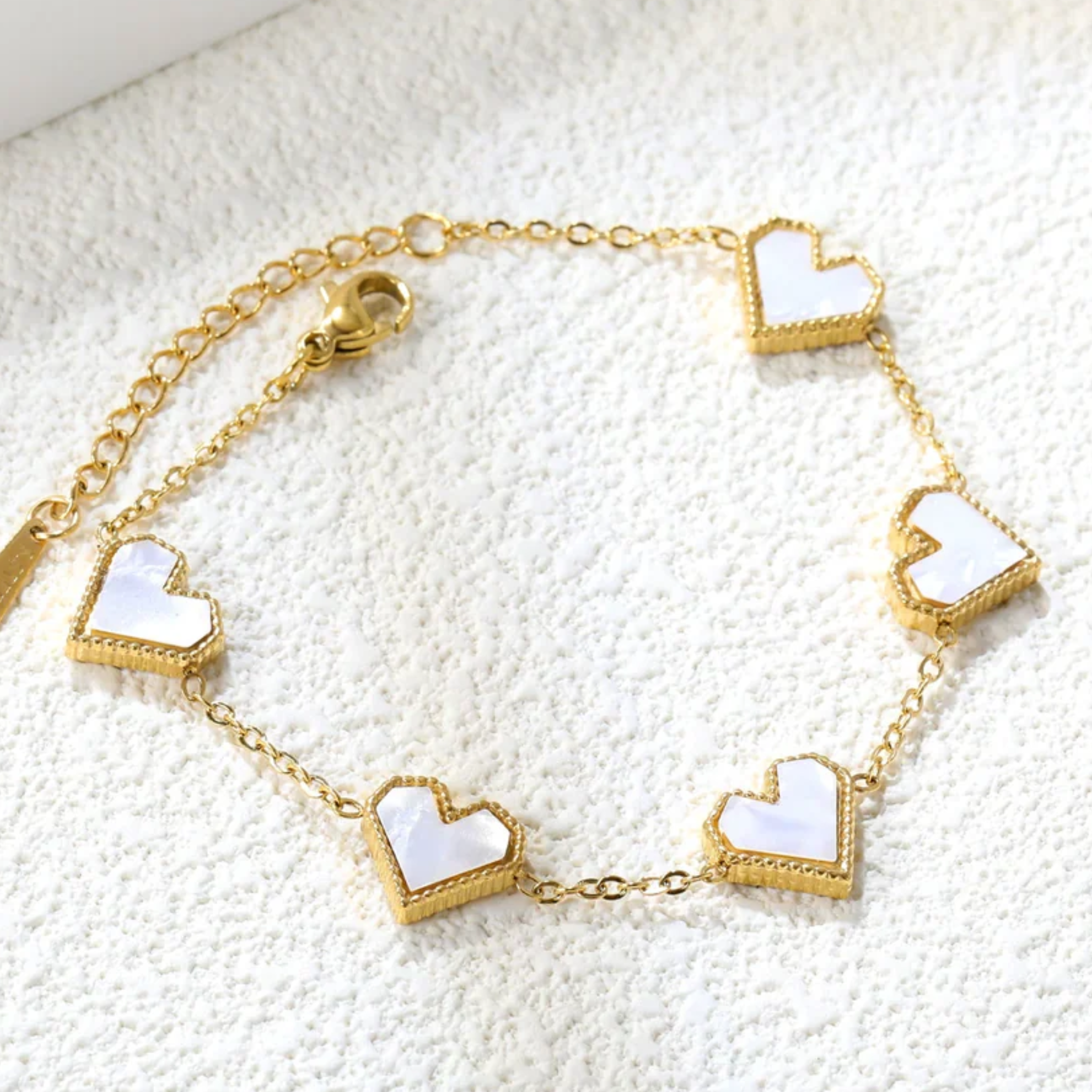 White heart shaped charms on a bracelet