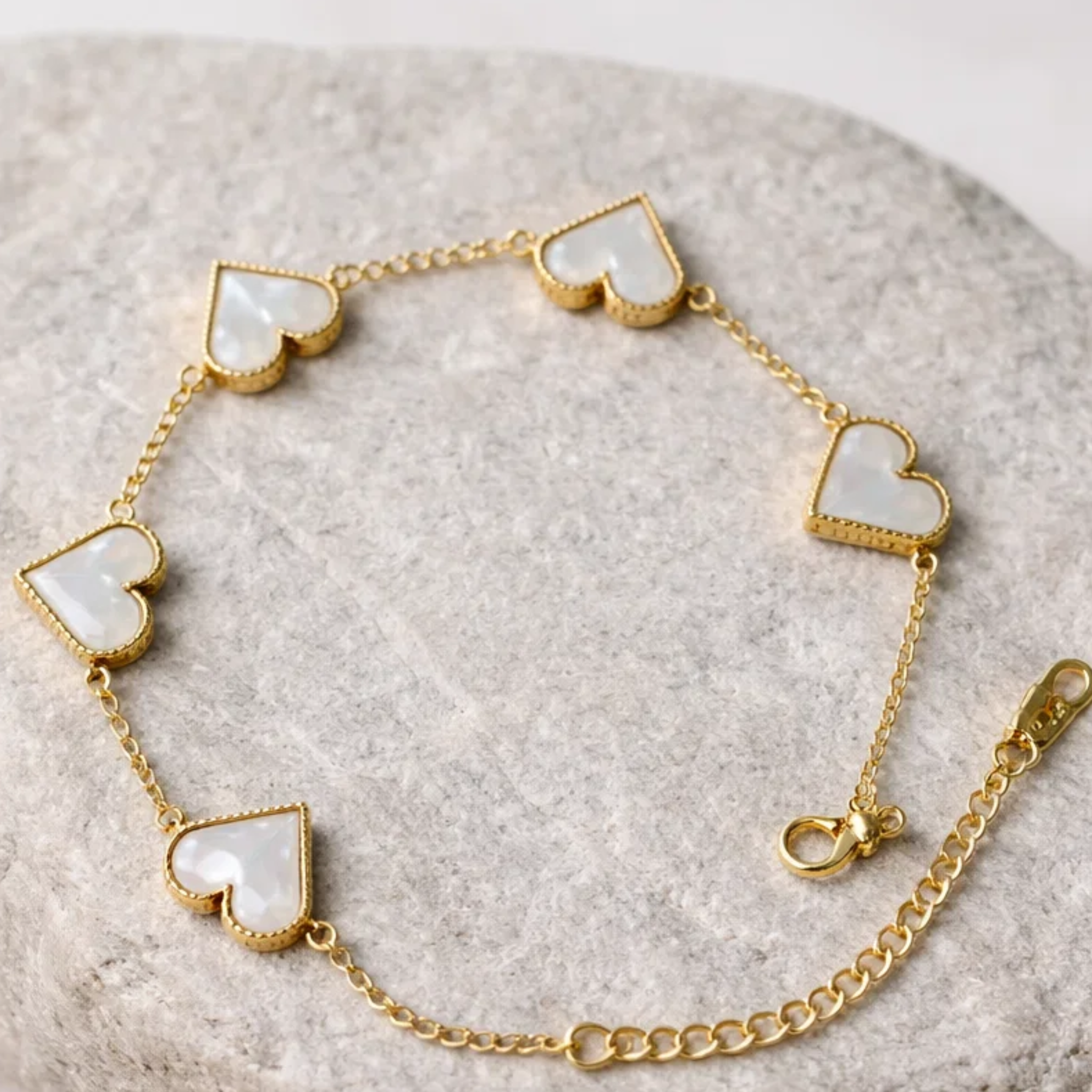 Heart-shaped bracelet on a stone surface