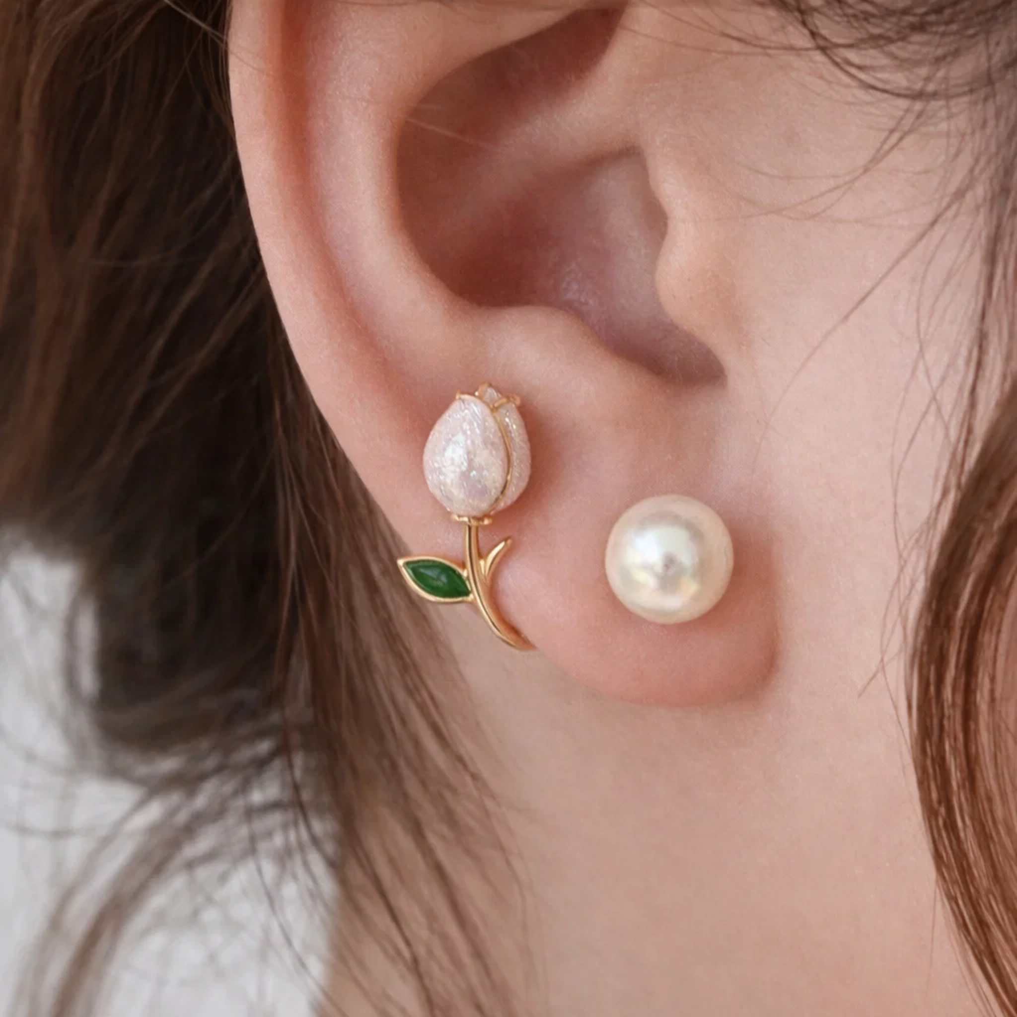 A woman wearing white tulip earrings