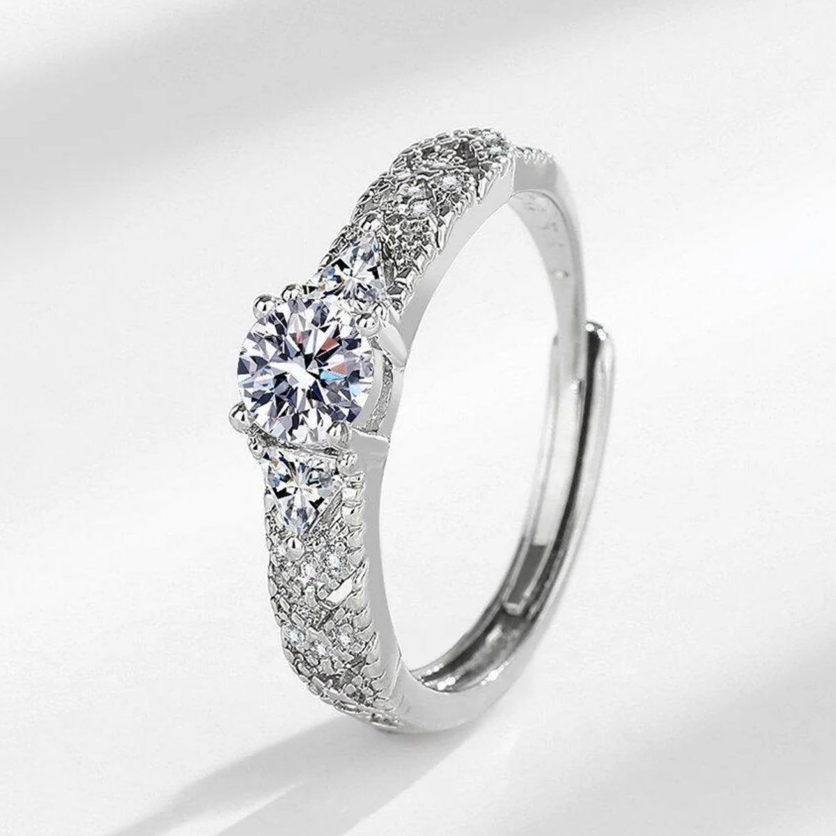 A silver-toned adjustable ring with a large round-cut center stone 